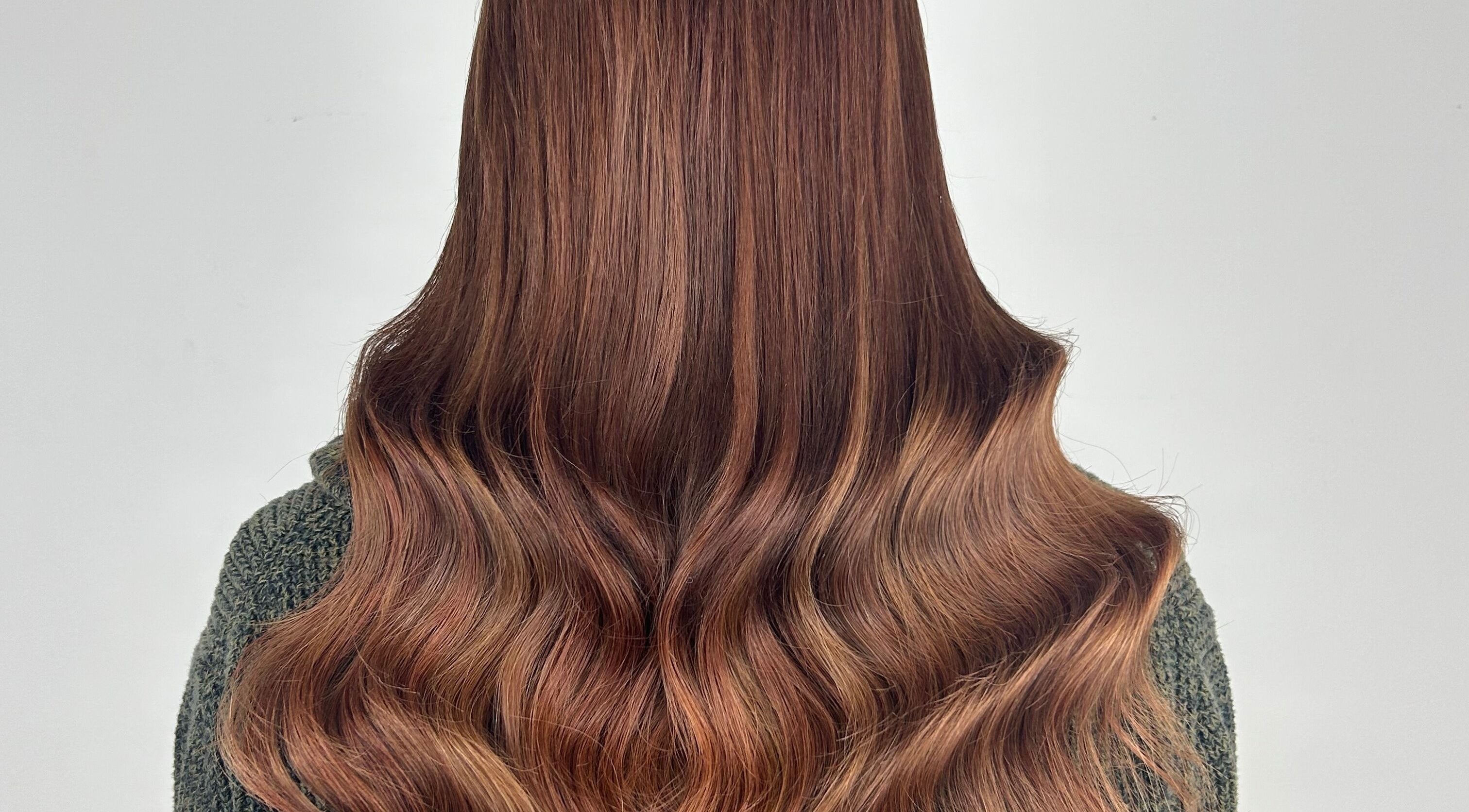 Lustrous auburn hair waves styled at Katie Brady Hair Extensions in Smiths Falls, Ontario, CA.