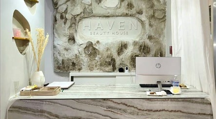 Reception desk with rocky backdrop at Haven Beauty House, Kingston, St. Andrew Parish, JM.