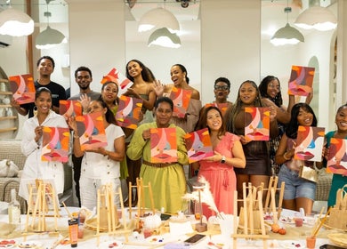 Group painting workshop at Haven Beauty House, Kingston, St. Andrew Parish, JM with vibrant abstract art.