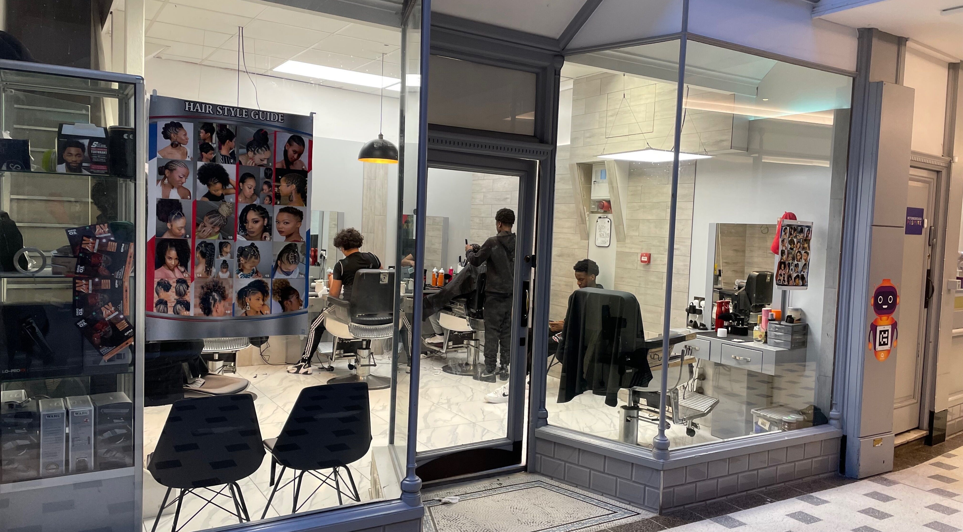 Lk Cutzz salon in Peterborough, England, GB, showcasing stylish barber setup with vibrant hair guides.