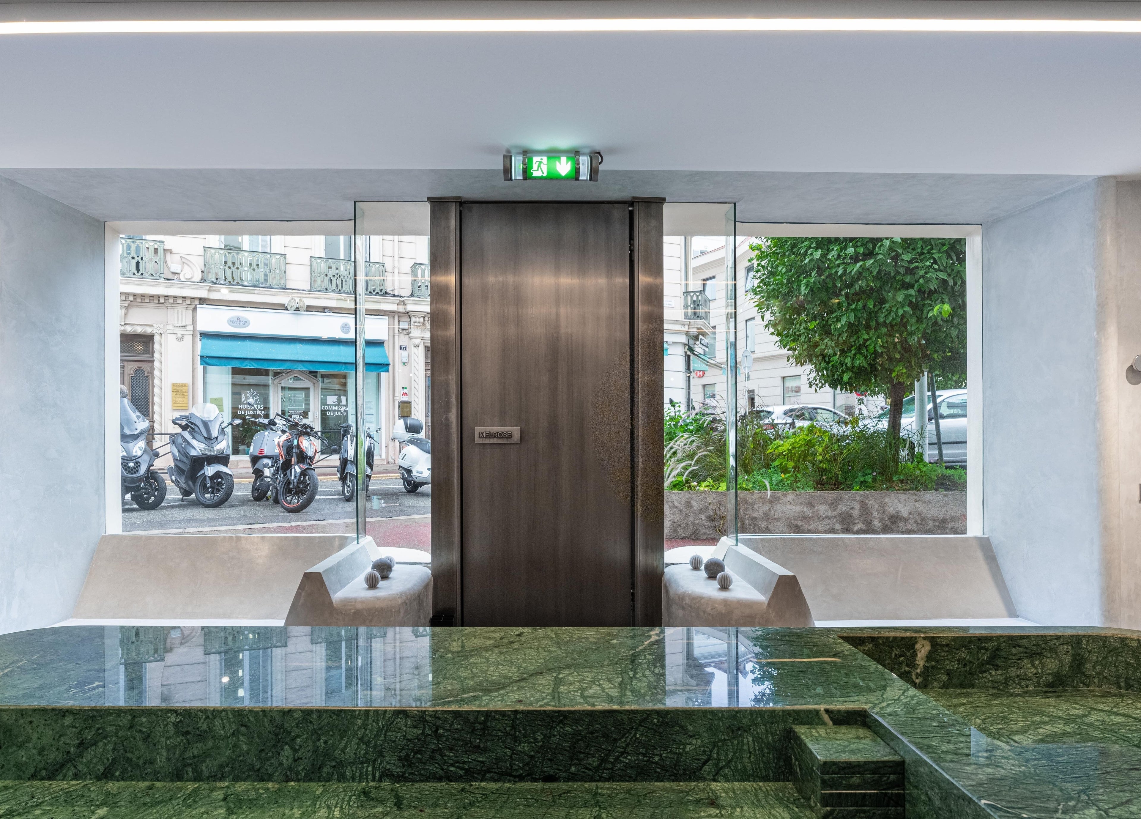 Modern entrance at Melrose in Cannes, Provence-alpes-côte D'azur, FR, showcasing sleek design and green stone decor.