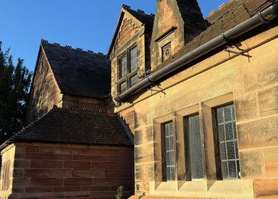 Charming stone exterior of Jennifer Young Wellness Clinic, Madeley, England, GB illuminated by sunlight.