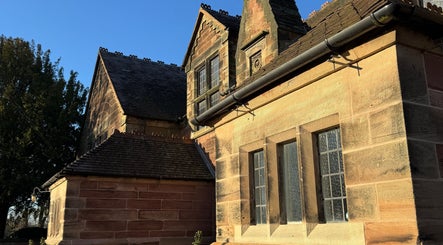 Charming stone exterior of Jennifer Young Wellness Clinic, Madeley, England, GB illuminated by sunlight.