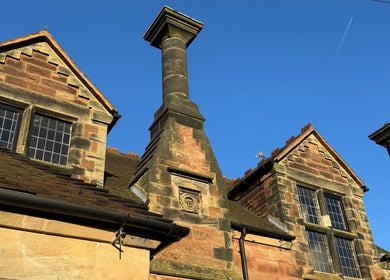 Historic architecture of Jennifer Young Wellness Clinic, Madeley, England, GB, under a clear blue sky.