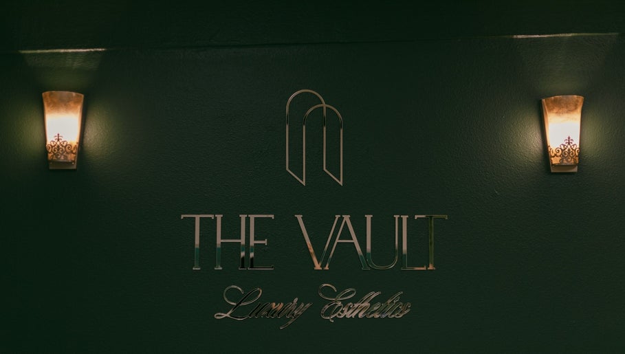 Entrance sign of The Vault - Luxury Esthetics in Hollister, California, US, with elegant lighting.