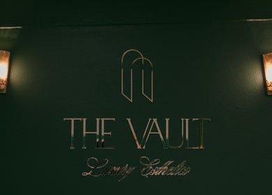 Entrance sign of The Vault - Luxury Esthetics in Hollister, California, US, with elegant lighting.