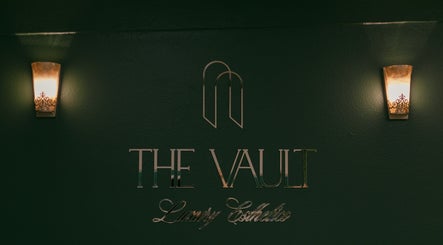 Entrance sign of The Vault - Luxury Esthetics in Hollister, California, US, with elegant lighting.