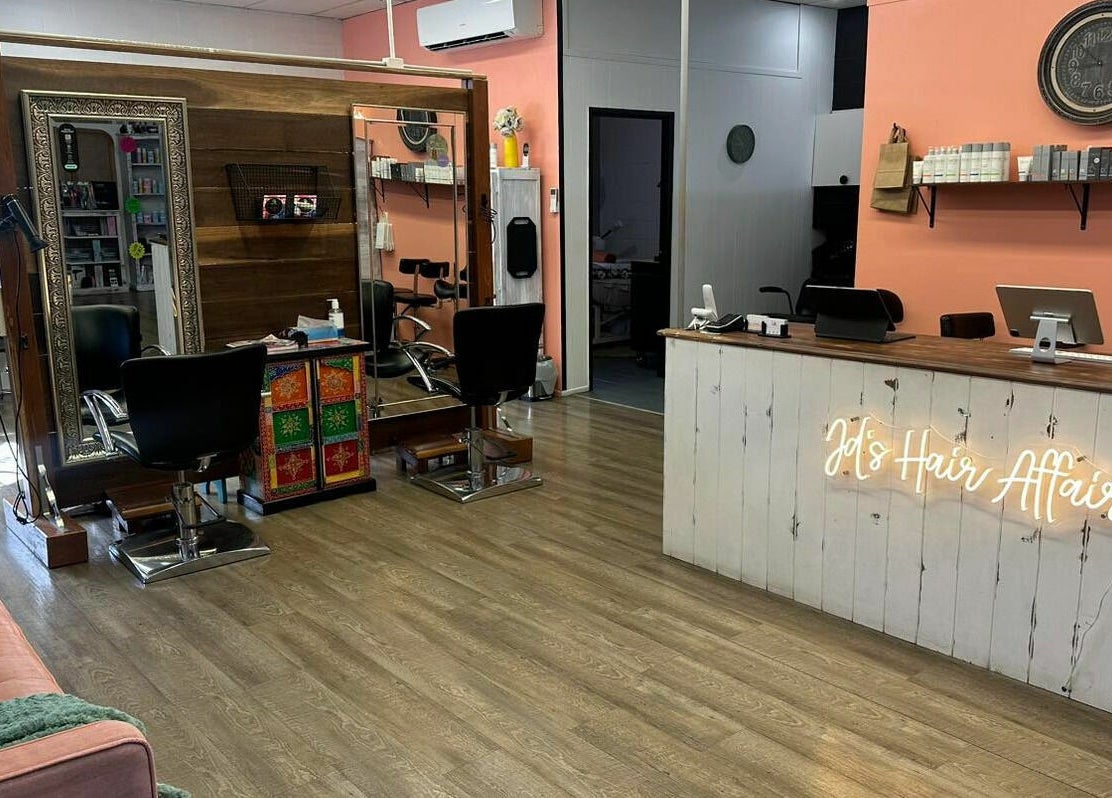 Chic interior at JD’s Hair Affair, Clermont, Queensland, AU with elegant mirrors and welcoming desk.