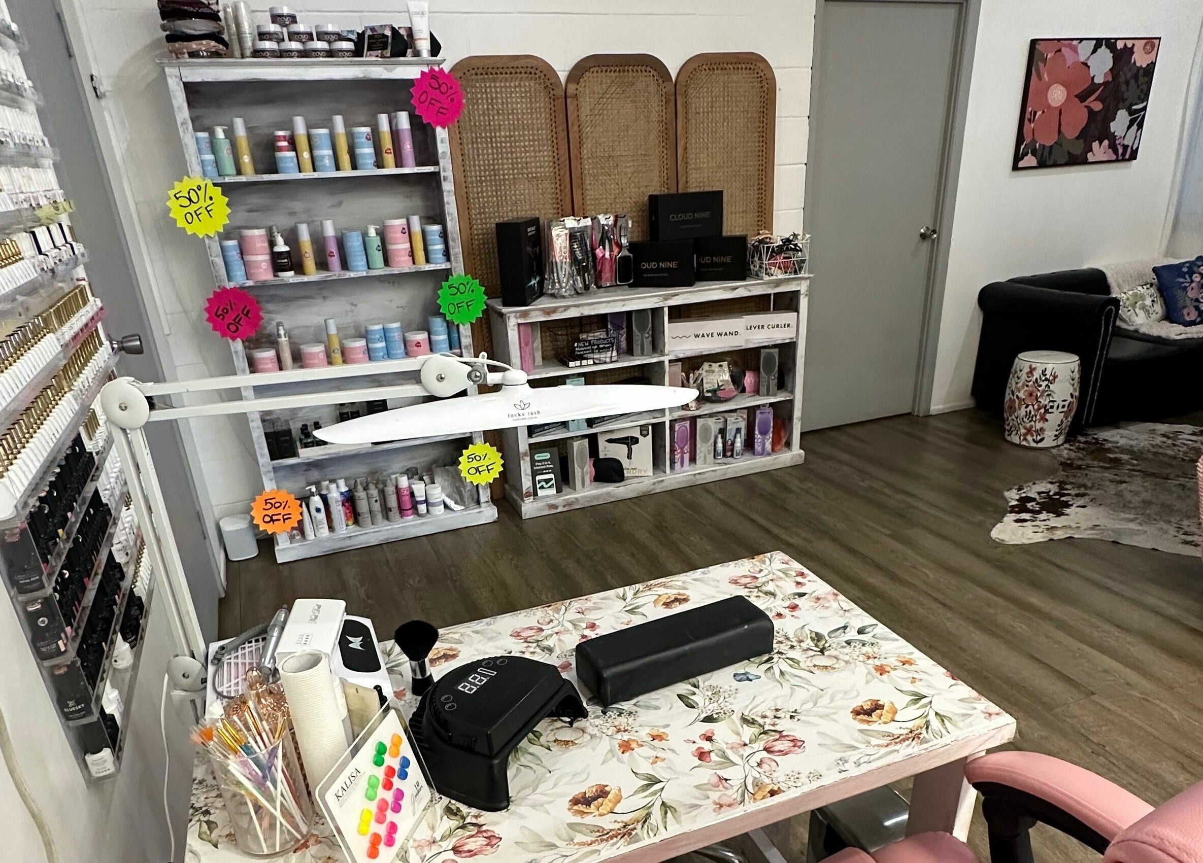 Elegant interior of JD’s Hair Affair, Clermont, Queensland, AU, showcasing beauty products and cozy seating.