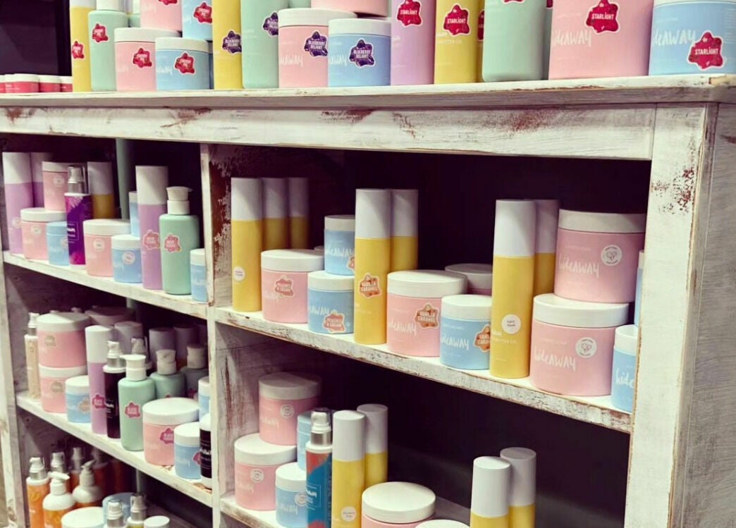 Vibrant hair care products on rustic shelves at JD’s Hair Affair, Clermont, Queensland, AU.