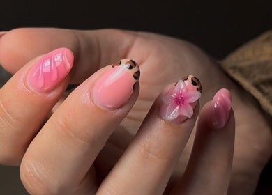 Elegant pink and leopard print nails with floral art at Lunar Beauty, Pleasley, England, GB.