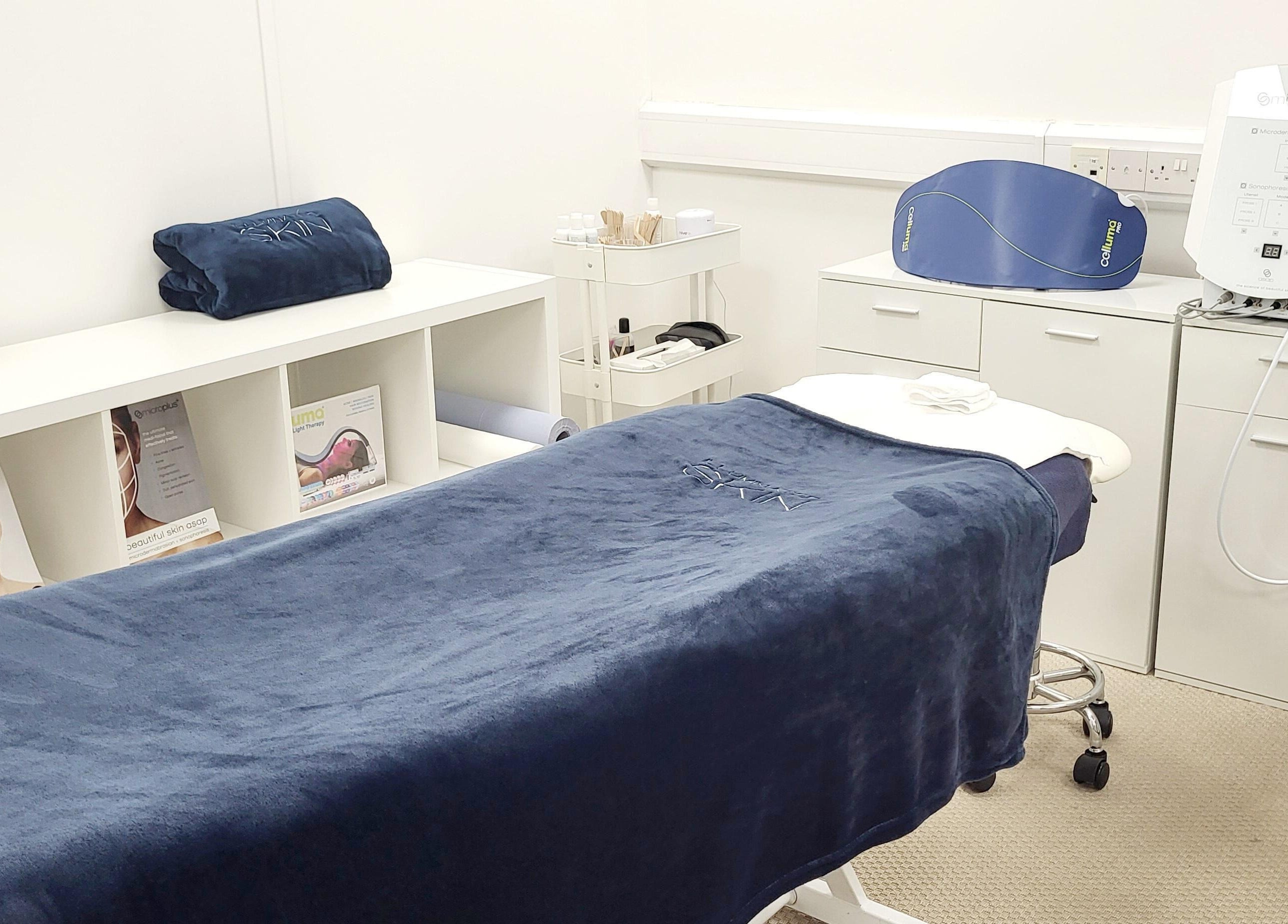 Calming treatment room at Illuminated Skin, Ardee, IE. Cozy bed, modern equipment, and stylish decor enhance relaxation.