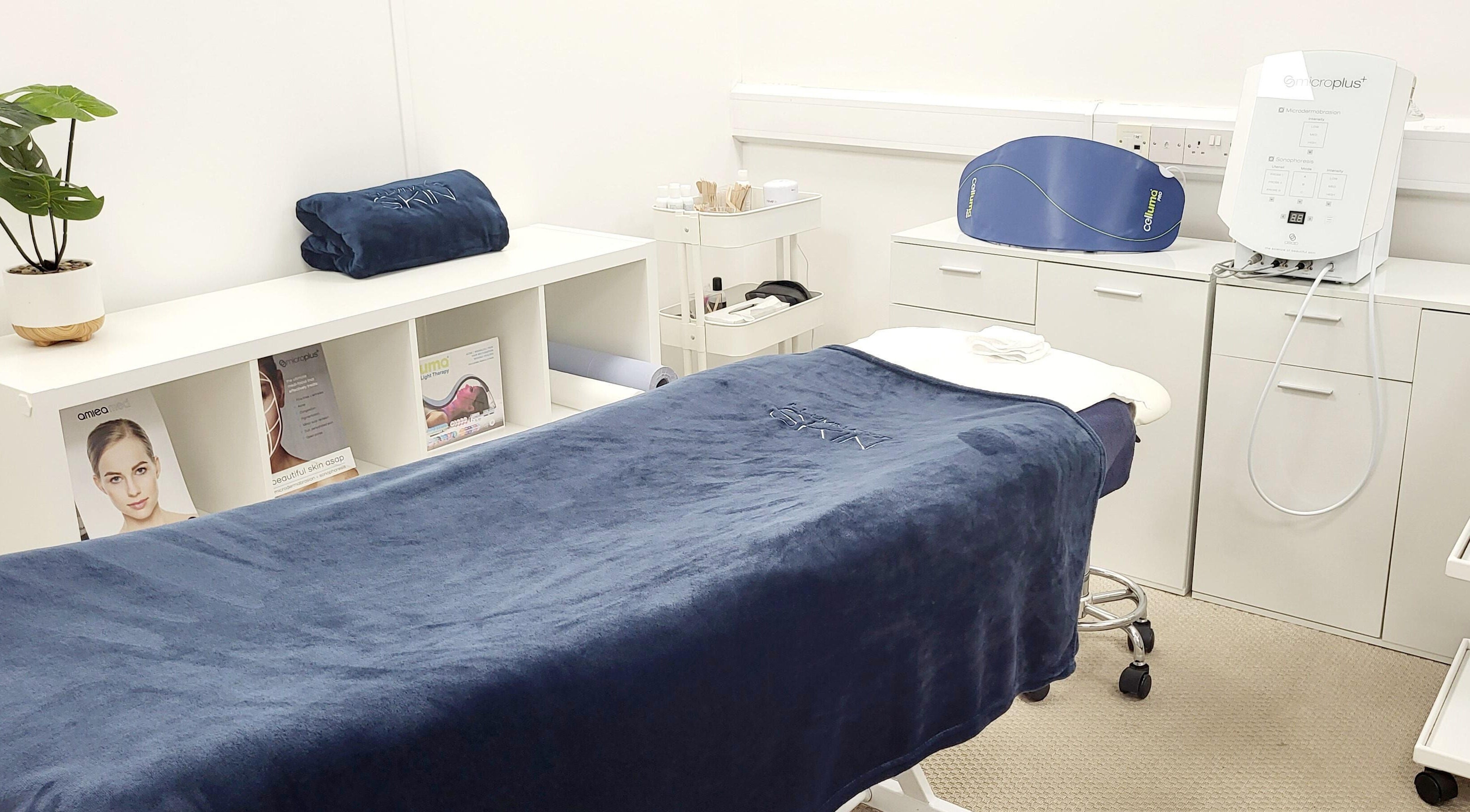 Calming treatment room at Illuminated Skin, Ardee, IE. Cozy bed, modern equipment, and stylish decor enhance relaxation.