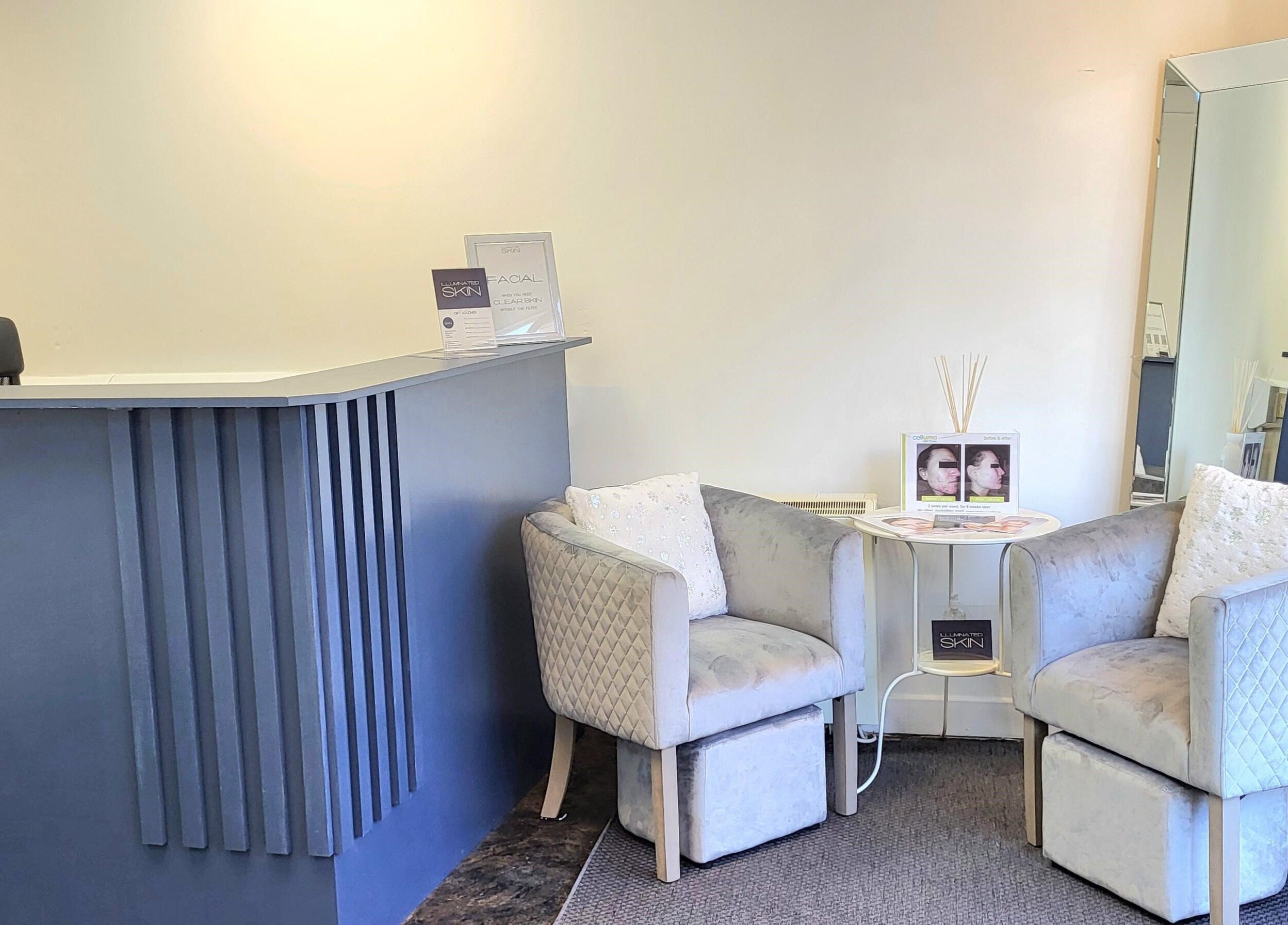 Cozy reception area at Illuminated Skin in Ardee, IE with plush chairs and elegant decor.