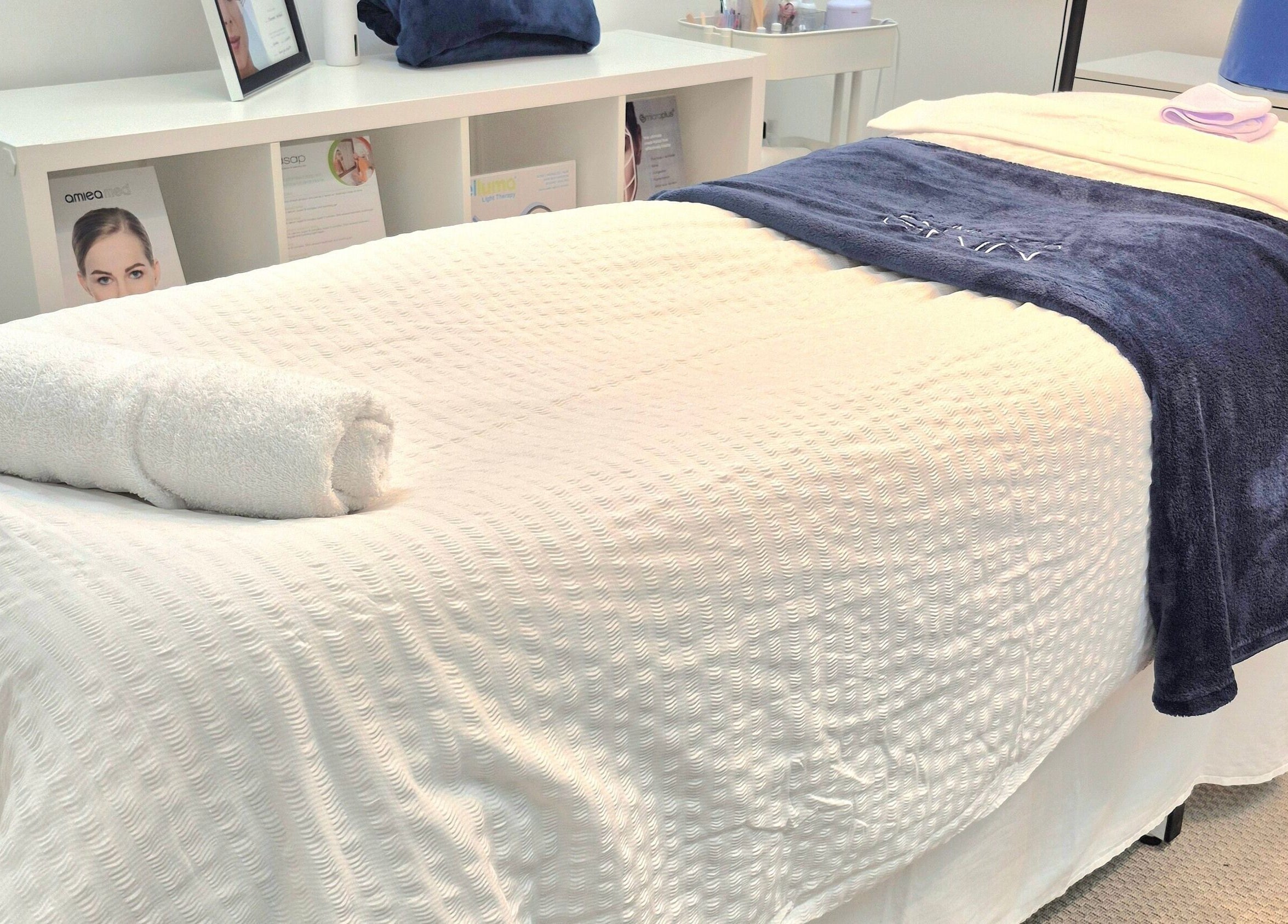 Relaxing treatment bed at Illuminated Skin, Ardee, IE, with plush towels and calming ambiance.