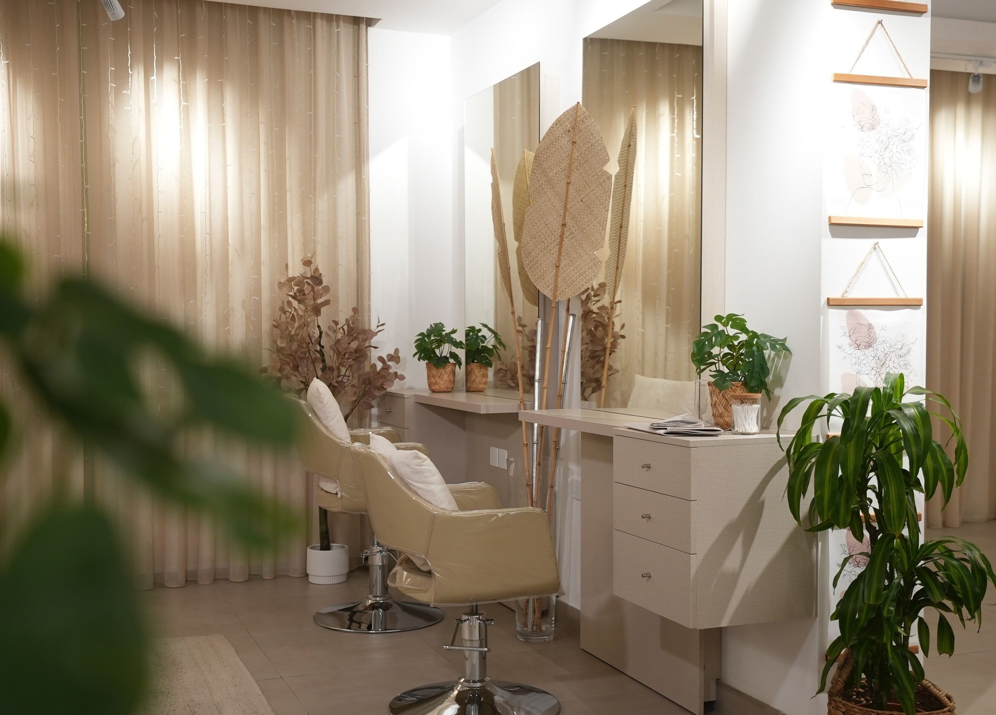 Stylish interior of The Room Boutique Salon in Jeddah, Makkah Province, SA, featuring chic chairs and lush plants.
