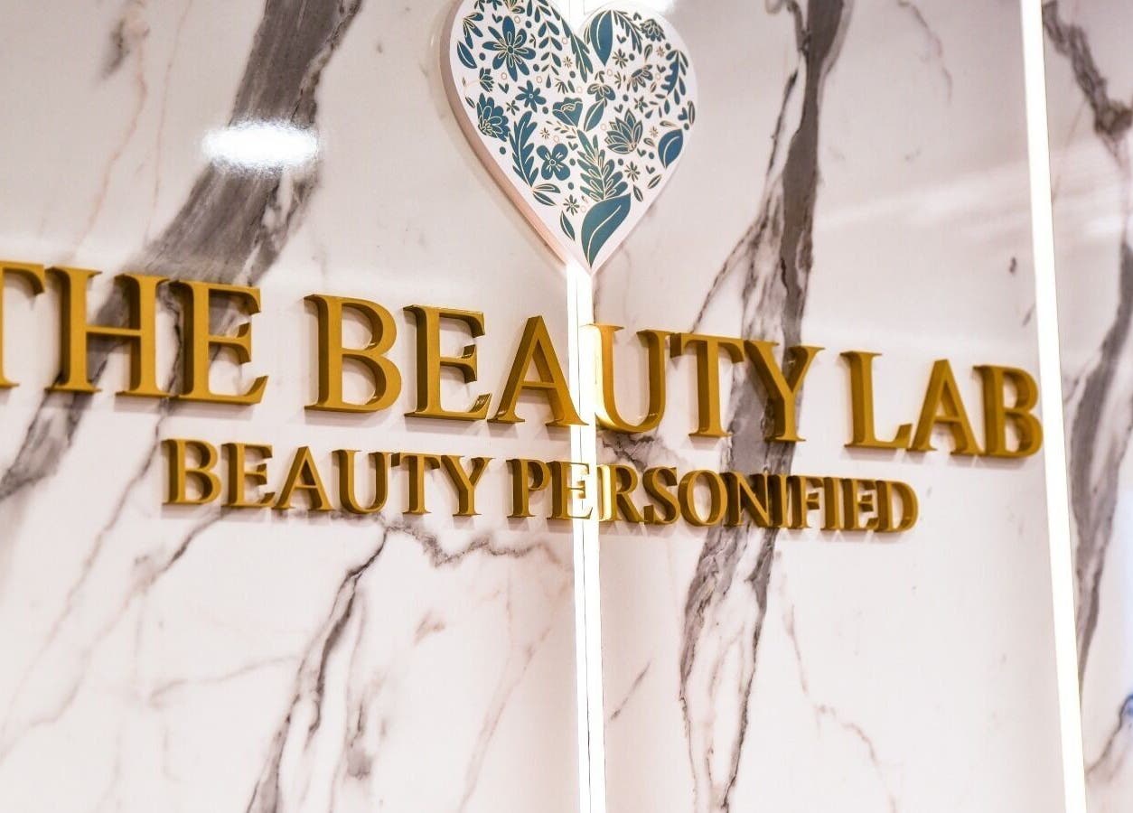 Elegant signage for The Beauty Lab Ladies Salon in Abu Dhabi, AE, on a marble wall.