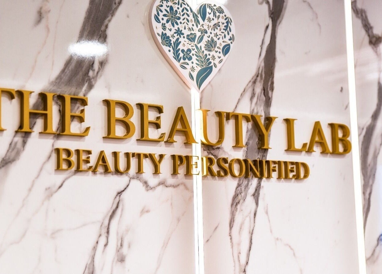 Elegant signage for The Beauty Lab Ladies Salon in Abu Dhabi, AE, on a marble wall.