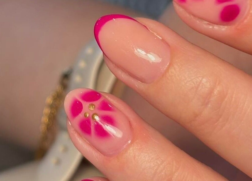Detailed pink floral nail art at KMbeauty, Ebbw Vale, Wales, GB, showcasing expert manicure skills.