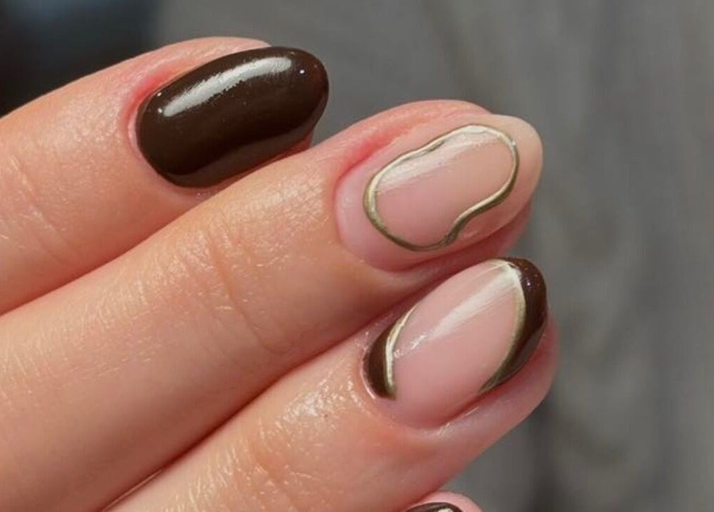 Elegant brown and nude nail art at KMbeauty, Ebbw Vale, Wales, GB offering a stylish manicure experience.