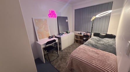 Cozy beauty treatment room at Beautybylibby, Maddington, Western Australia with a lash studio sign and bed.