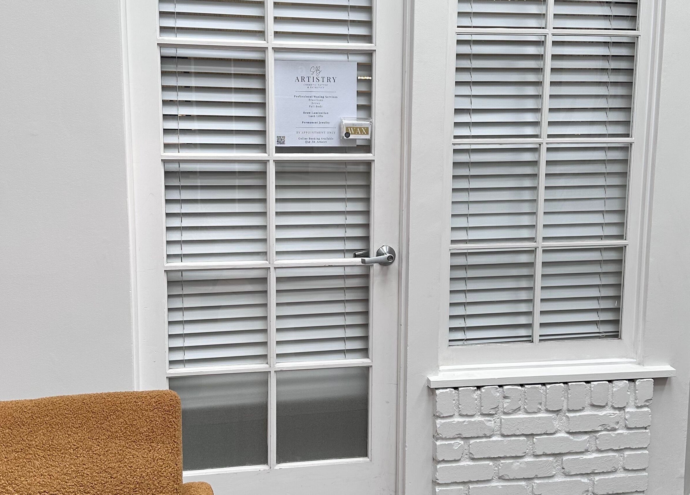 Entrance of SB Artistry with white door and window in Costa Mesa, California, US.