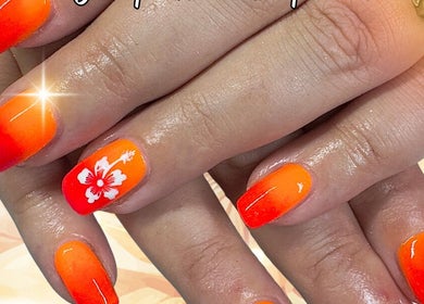 Vibrant orange nails with floral design at The Nail Sanctuary Blackpool, Blackpool, England, GB.