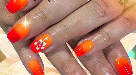 Vibrant orange nails with floral design at The Nail Sanctuary Blackpool, Blackpool, England, GB.