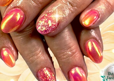 Vibrant coral nails with glitter at The Nail Sanctuary Blackpool, Blackpool, England, GB.