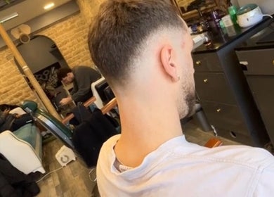 Modern interior of Hm Barbers in London, England, GB, showcasing stylish haircut and comfortable seating area.