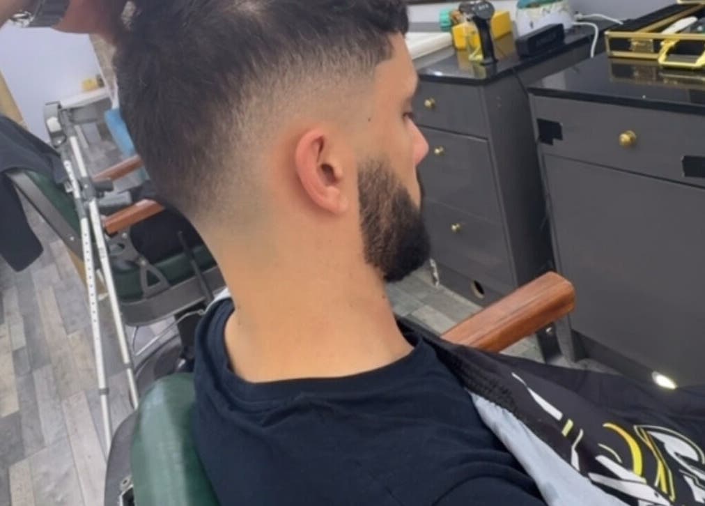 Man receives a stylish fade haircut at HM Barbers, London, England, GB.