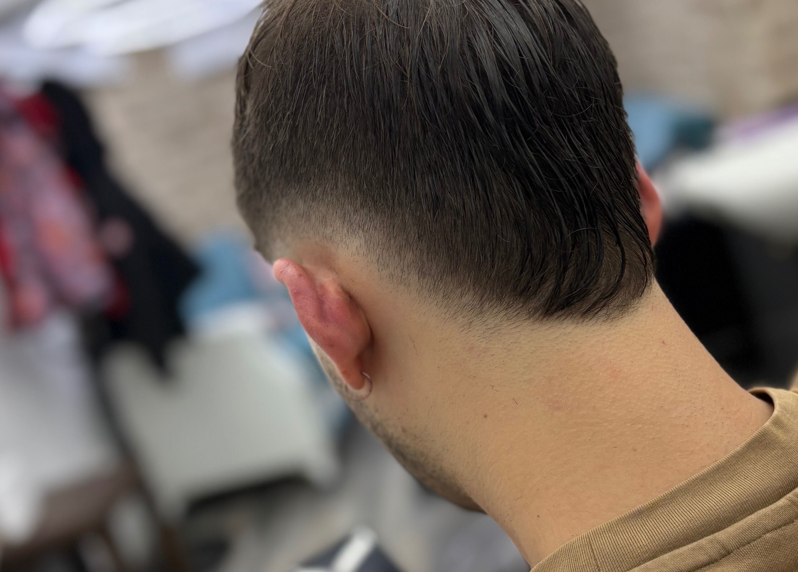 Close-up of a sleek fade haircut at Hm Barbers, London, England, GB in a modern styling setting.