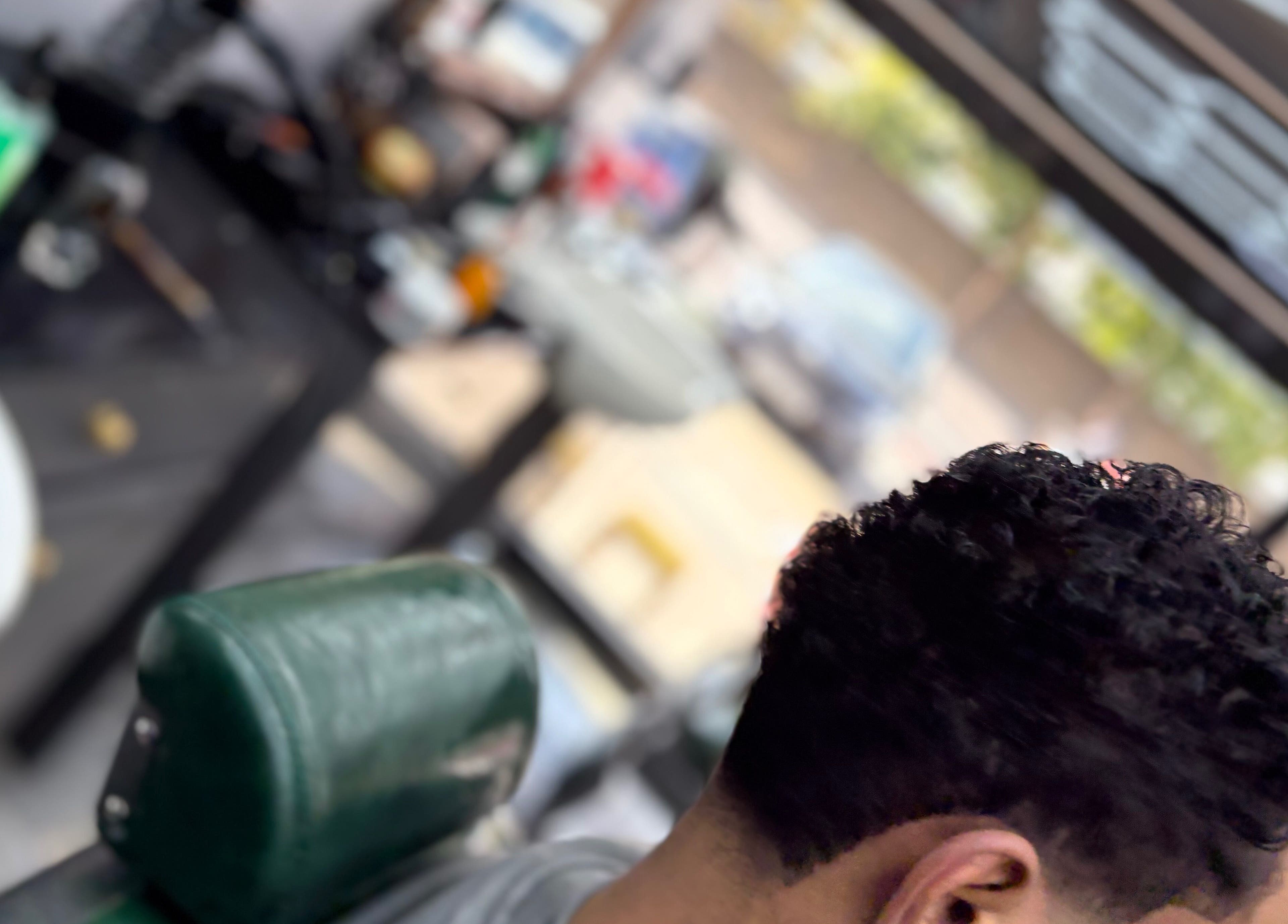 Fresh haircut at Hm barbers in London, England, GB. Close-up of a customer's styled hair in a barber chair.