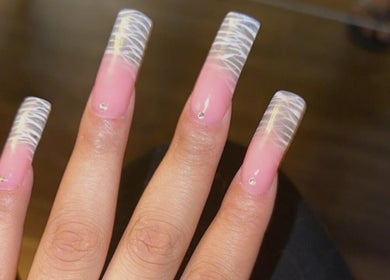 Elegant pink and white acrylic nails at Sheer Dollz, London, England, GB showcasing intricate nail art.