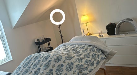 Cozy treatment room at Rebecca Duffy Advanced Skin, Belfast, Northern Ireland, GB with soothing lighting and decor.