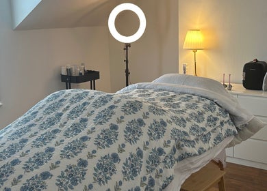 Treatment room at Rebecca Duffy Advanced Skin, Belfast, Northern Ireland, GB with cozy bedding and ambient lighting.