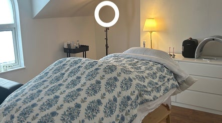 Treatment room at Rebecca Duffy Advanced Skin, Belfast, Northern Ireland, GB with cozy bedding and ambient lighting.