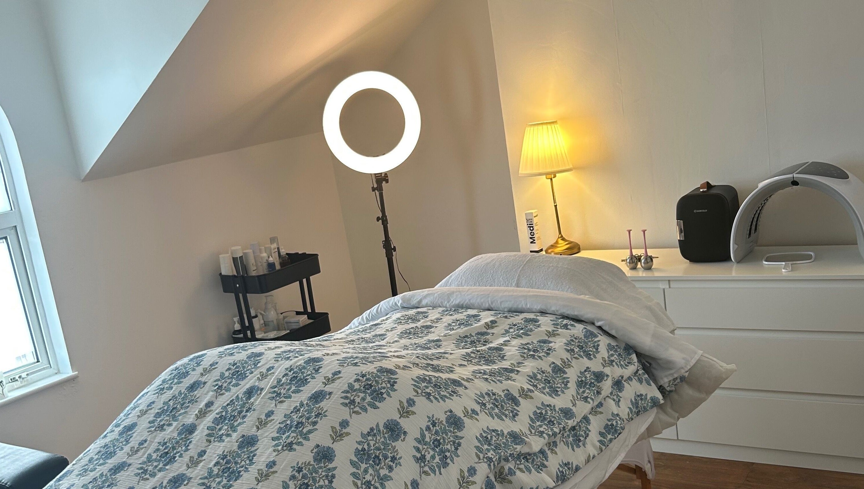 Cozy treatment room at Rebecca Duffy Advanced Skin, Belfast, Northern Ireland, GB, with comfy bed and soft lighting.