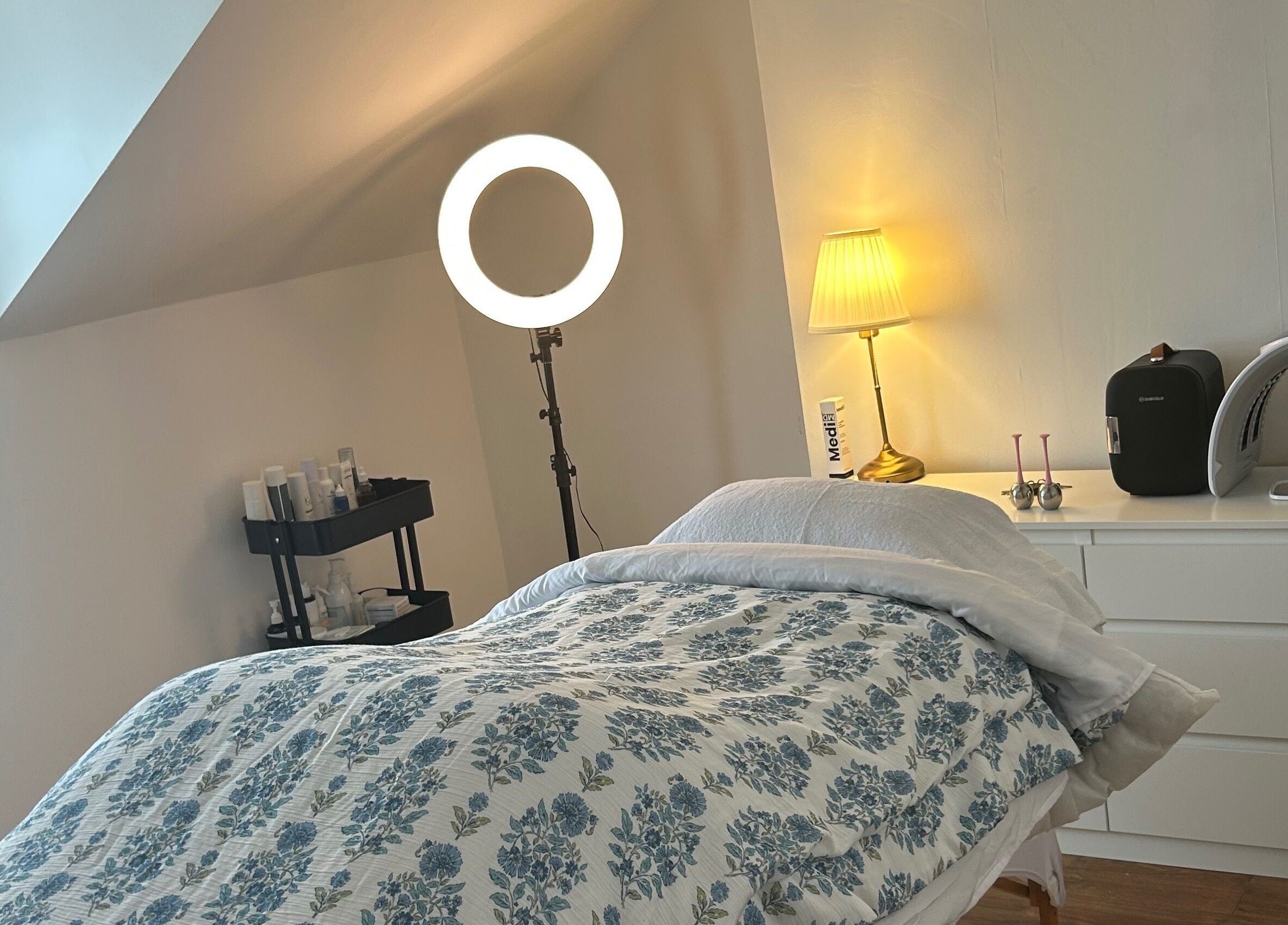 Cozy treatment room at Rebecca Duffy Advanced Skin, Belfast, Northern Ireland, GB, with comfy bed and soft lighting.