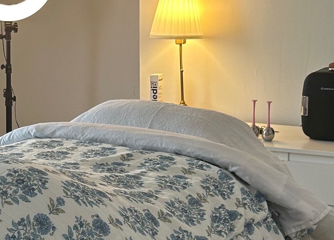 Cozy treatment room at Rebecca Duffy Advanced Skin, Belfast, Northern Ireland, GB, featuring floral bedding.