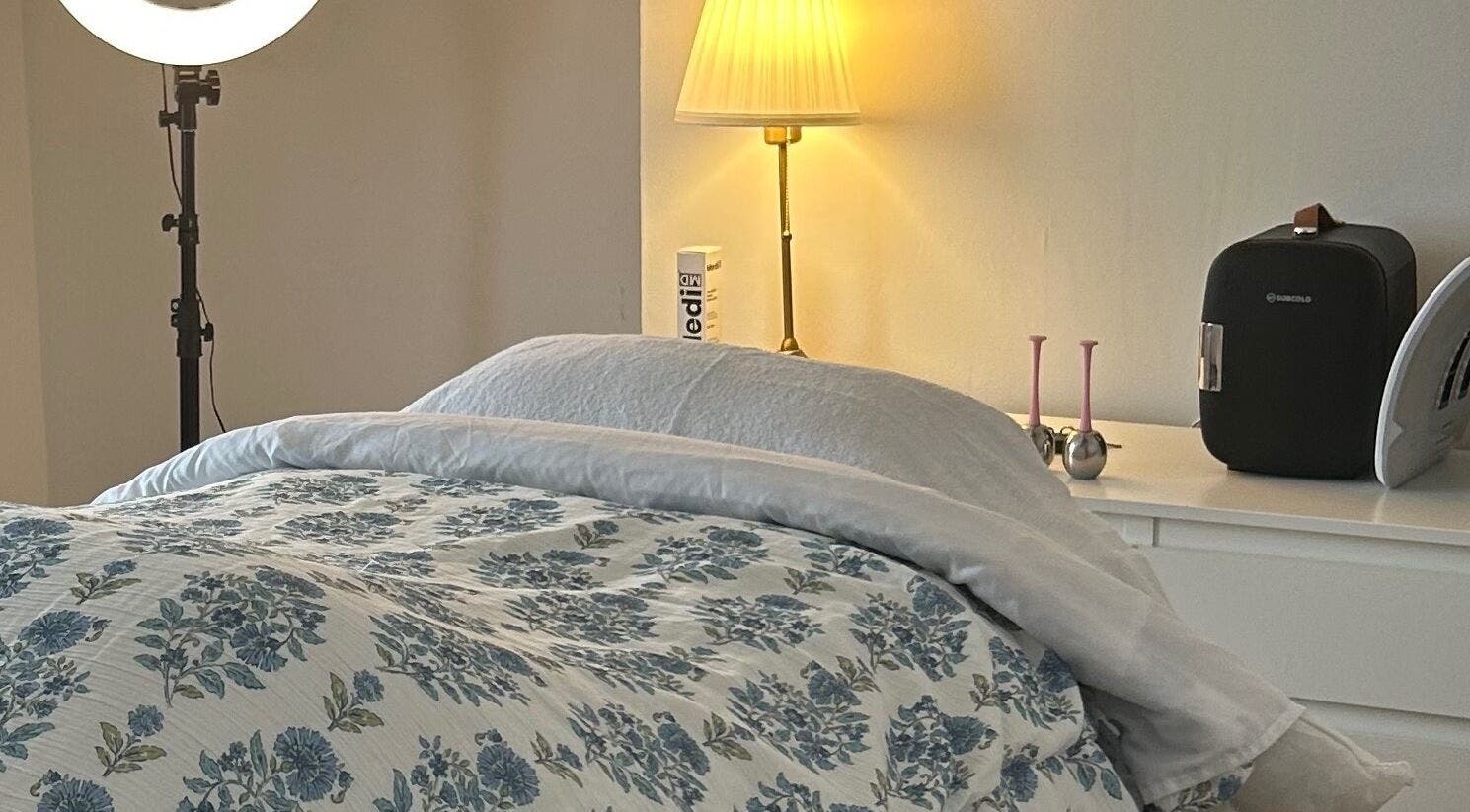 Cozy treatment room at Rebecca Duffy Advanced Skin, Belfast, Northern Ireland, GB, featuring floral bedding.