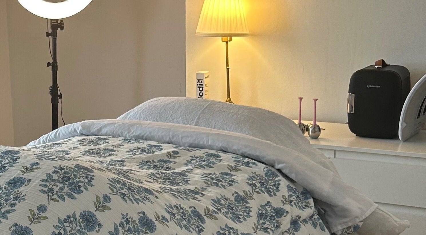 Cozy treatment room at Rebecca Duffy Advanced Skin, Belfast, Northern Ireland, GB, featuring floral bedding.