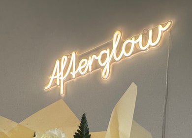 Neon sign at Afterglow Beauty Ltd, Goole, England, GB with soft yellow glow and floral decor.