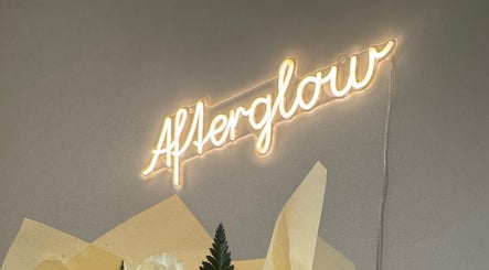 Neon sign at Afterglow Beauty Ltd, Goole, England, GB with soft yellow glow and floral decor.
