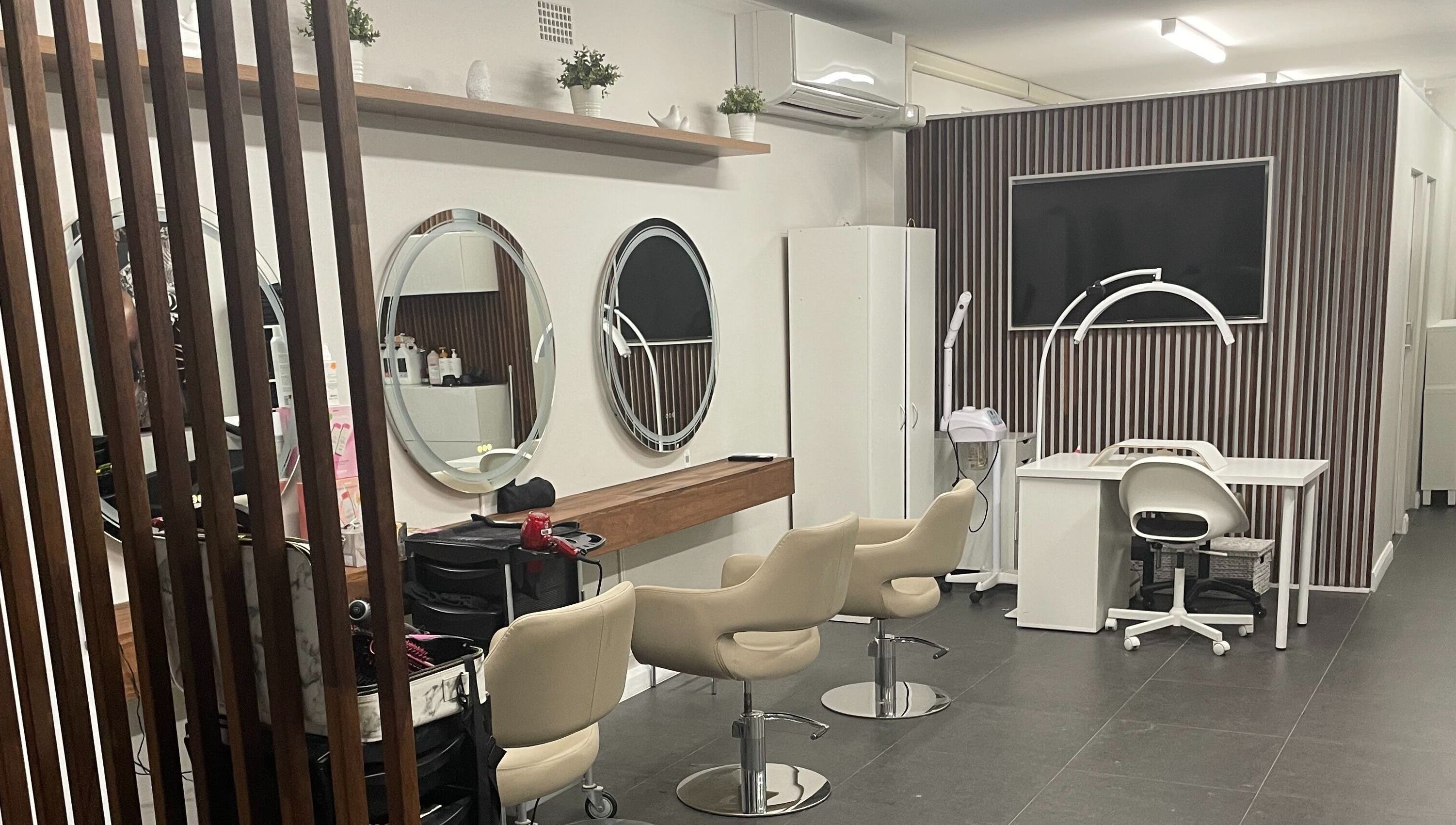 Interior of Carmen Marie Beauty salon in Maroubra, New South Wales, AU showcasing stylish chairs and mirrors.