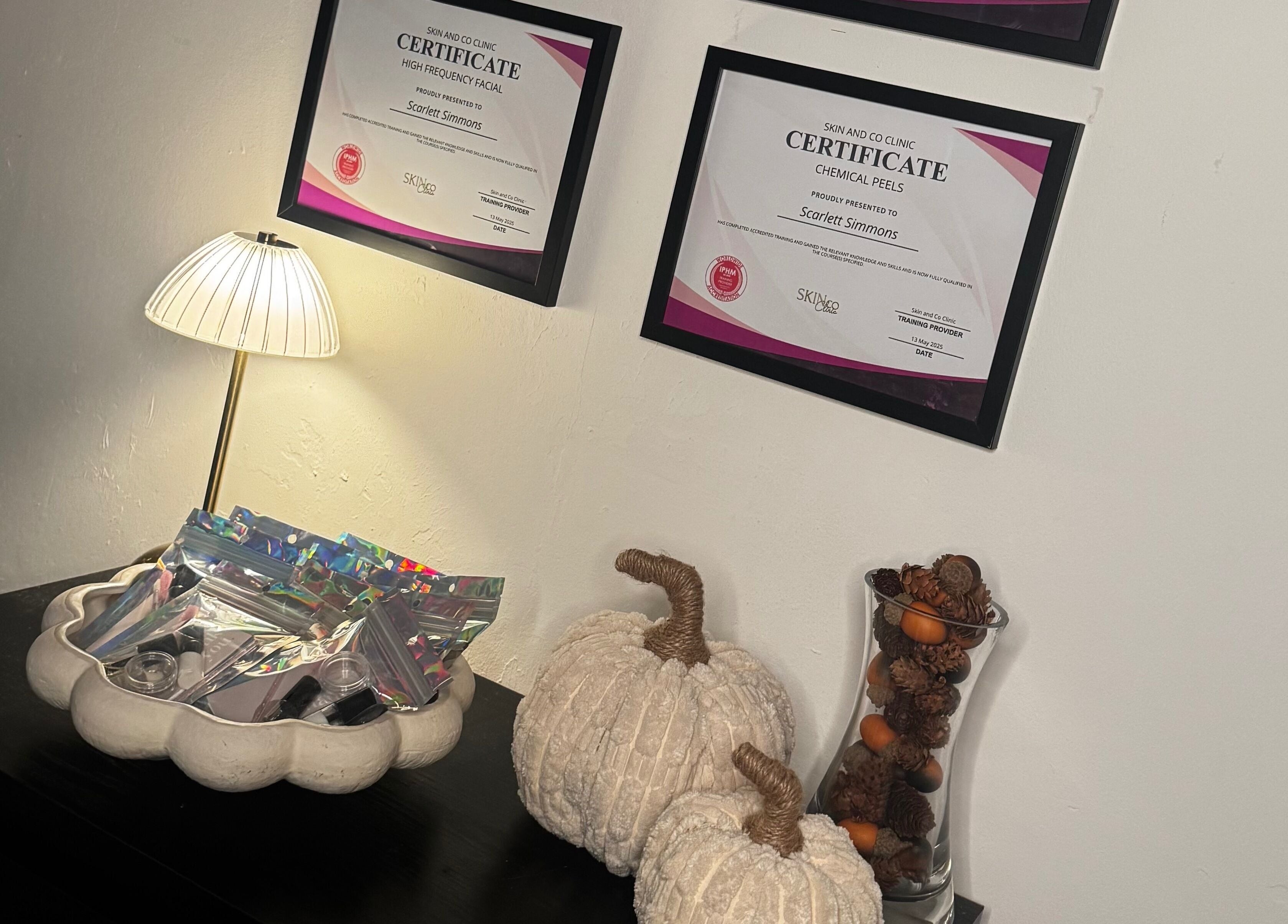 Certificates and decor at Lash Box Mcr, Greenmount, England, GB, showcasing a warm and professional ambiance.