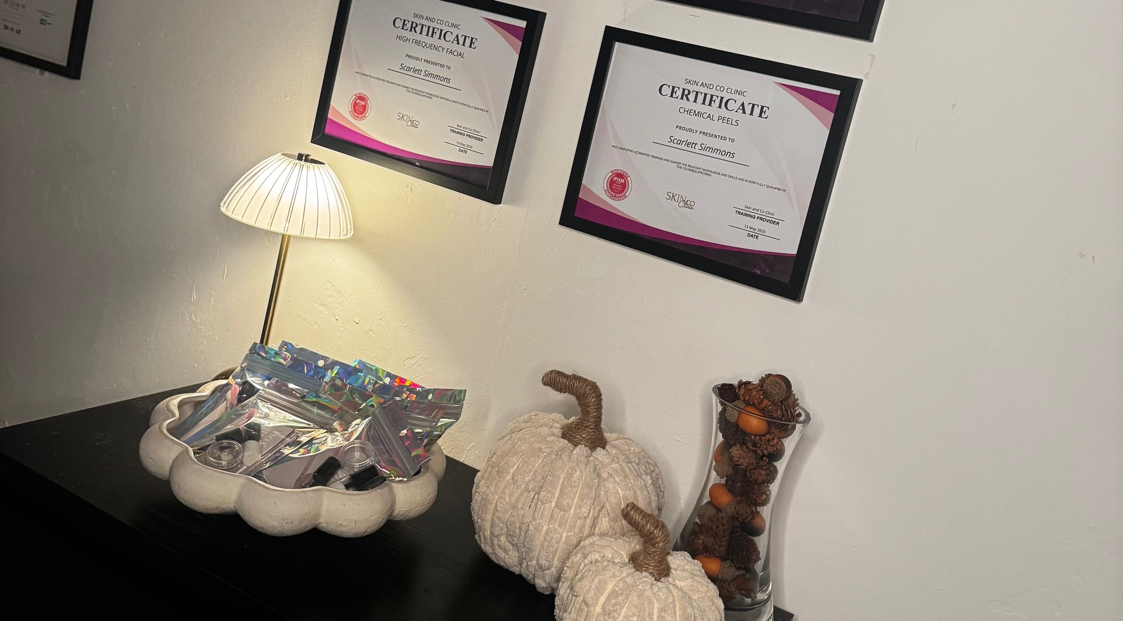 Certificates and decor at Lash Box Mcr, Greenmount, England, GB, showcasing a warm and professional ambiance.