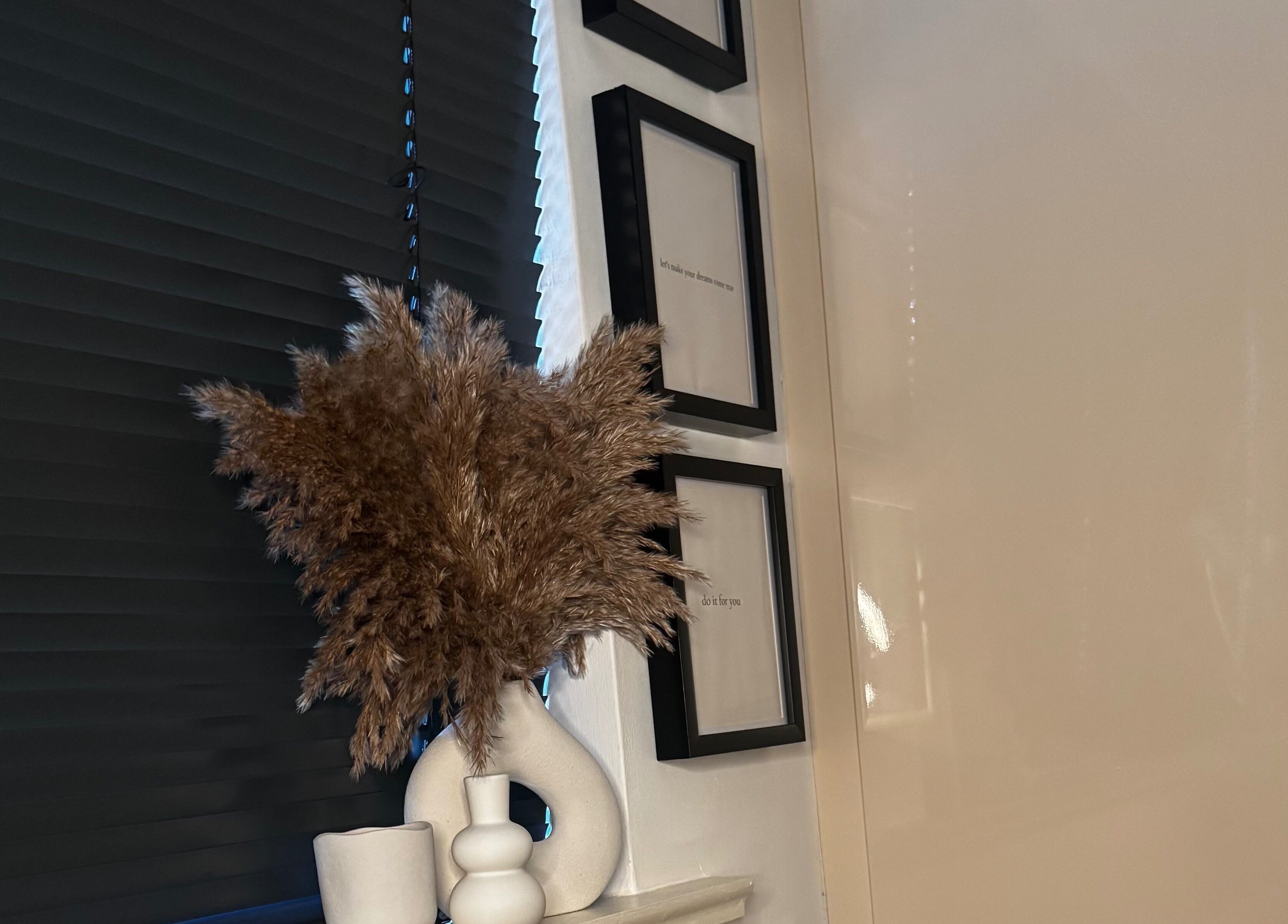 Chic arrangement with dried pampas grass and frames at Lash Box Mcr, Greenmount, England, GB.