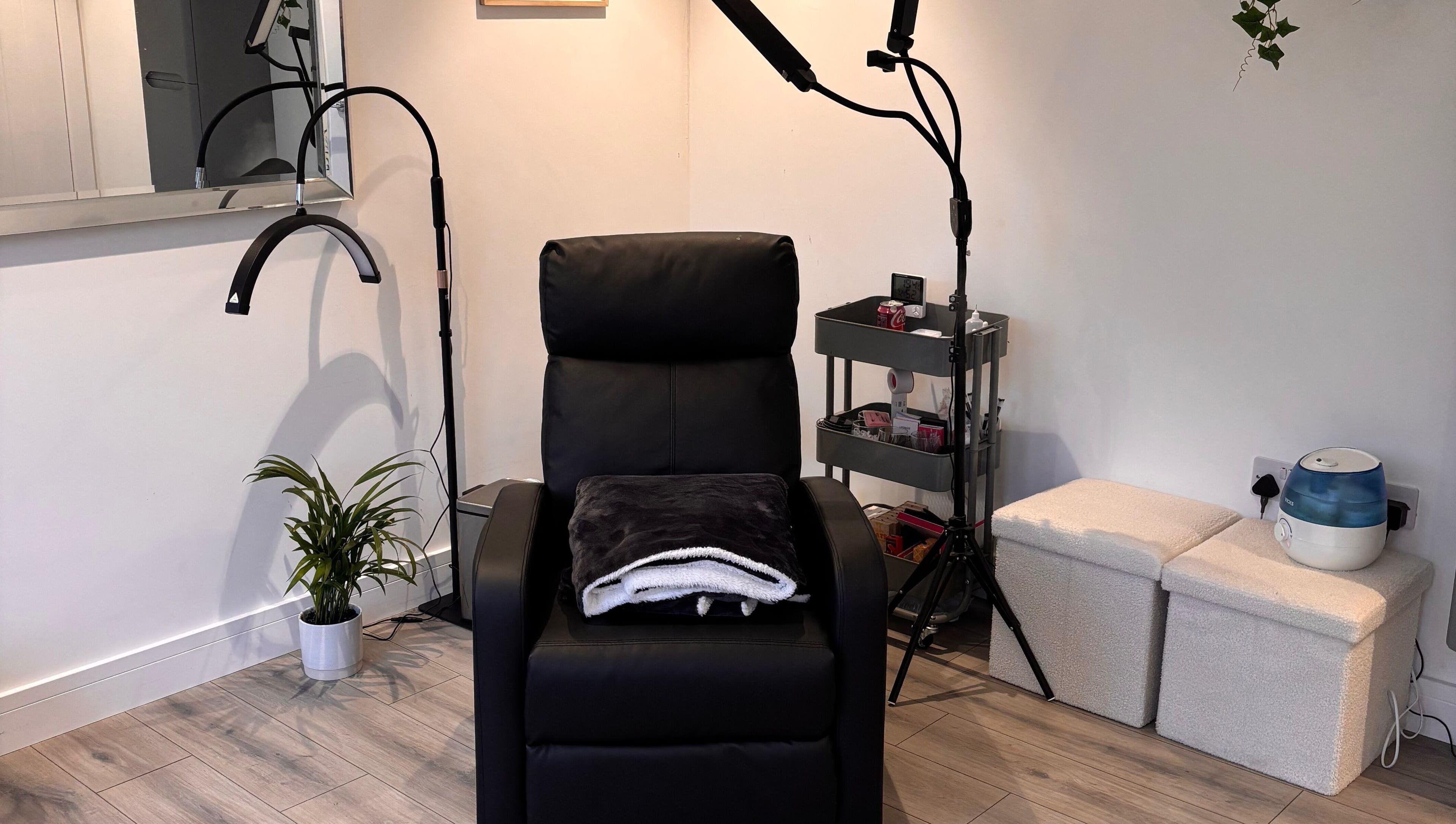 Comfortable treatment chair at Beauty Hall in Watford, England, GB, surrounded by minimalist decor.