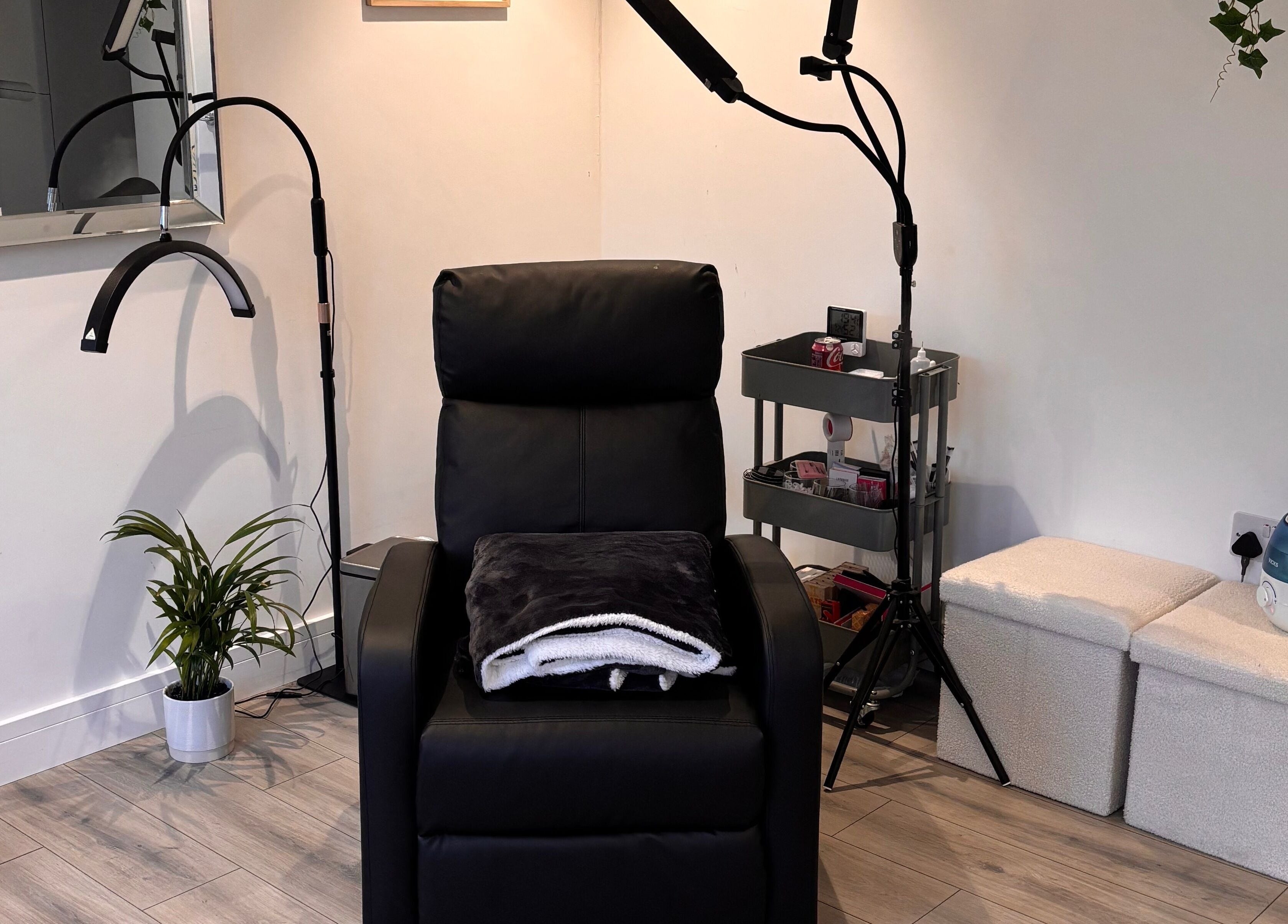 Comfortable treatment chair at Beauty Hall in Watford, England, GB, surrounded by minimalist decor.